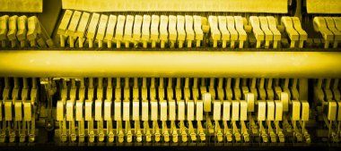 Details of piano mechanism gavel - string, pins and hammers, piano from 1973