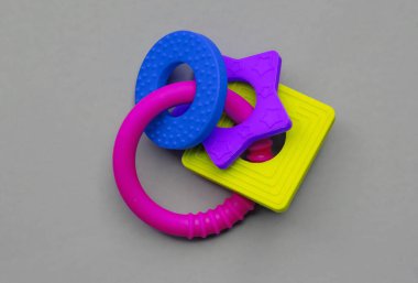 Silicone teether ring for baby isolated on grey background