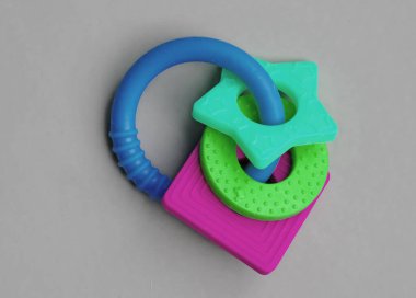 Silicone teether ring for baby isolated on grey background