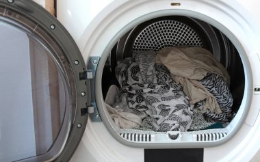 Laundry in the tumble dryer, selective focus clipart