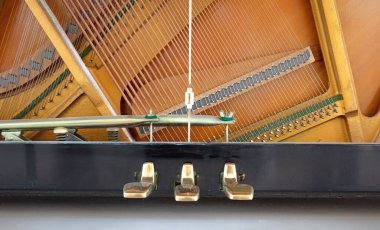 Old piano pedal with close-up shot, old pedal with scratches and dust