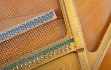 Details of piano mechanism gavel - string, pins and hammers, piano from 1973
