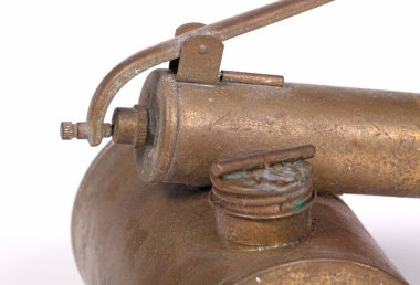 Old brass insecticide spray on a white background