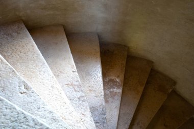 Fransız binasındaki taş spiral bir merdivenin yakın plan çekimi, seçici odaklı.