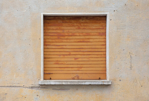 Residential house protected by a metal shutter in front of a window