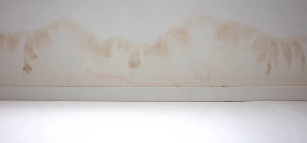 Stains on ceiling and wall from water leak, selective focus