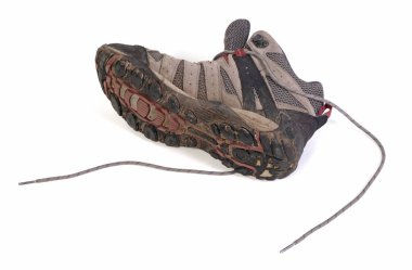 Worn-out muddy lace-up hiking boots, no live in them anymore, isolated clipart
