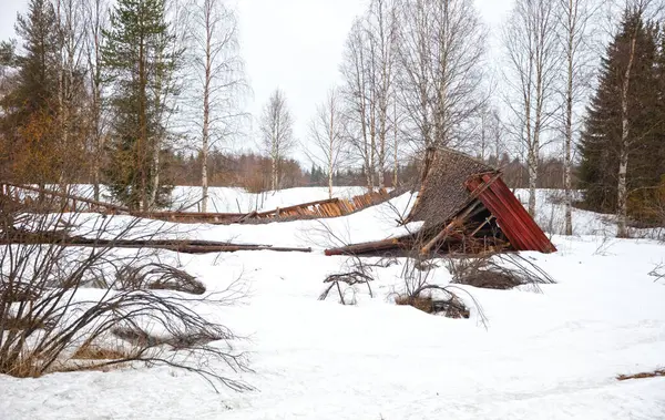 stock image Collapsed structure destroyed by snowfall in Finland, end of winter