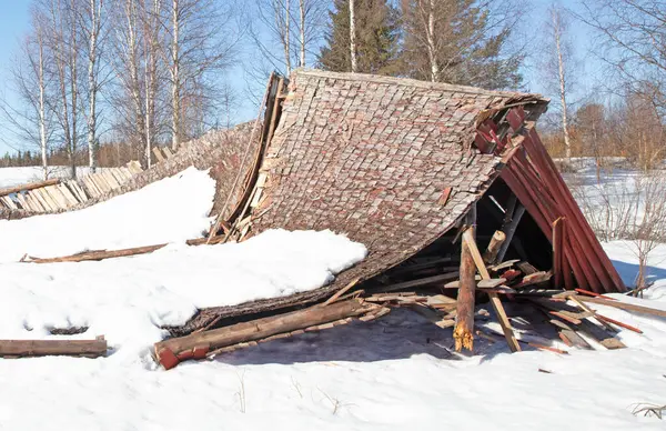 stock image Collapsed structure destroyed by snowfall in Finland, end of winter