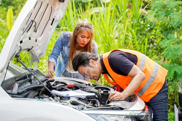 Closeup auto mechanic checking for breakdowns and list repairs according to customer orders