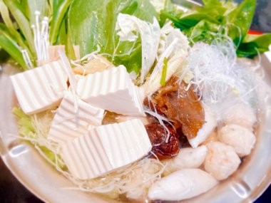 Sebzeler, soya peyniri ve balık köfteleriyle Japon güvecini yakın ve hasat et..