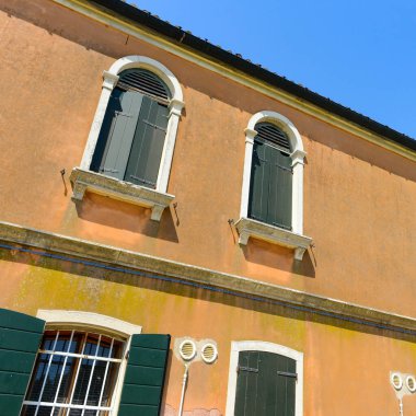 Old wooden door and window in a house in burano Island, Ital