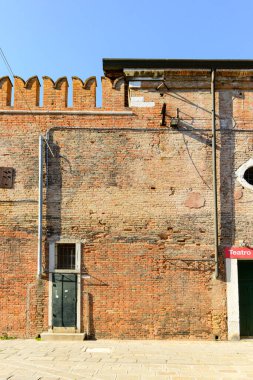 Front view of traditional vintage door with old house in historic  Venice, Italy.