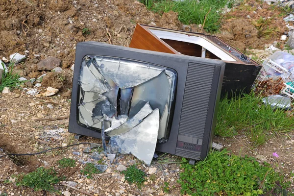 旧电视机在垃圾场坏了 垃圾倒地把电视屏幕拆成碎片 污染环境 — 图库照片
