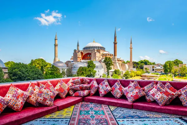 stock image Hagia Sophia in Istanbul, Turkey. Great panoramic view of Istanbul from high terrace decorated traditional colorful ornamental pillows and carpets and still life.