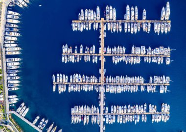 Aerial view of yacht marina. Drone footage over the moored boats at the marina on a sunny day. clipart