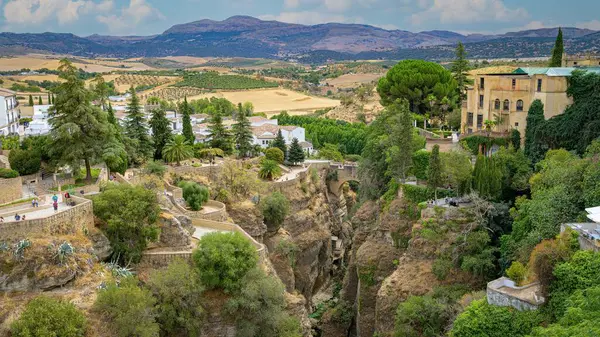 Ronda 'daki Puente Viejo köprüsü, arka planda tarlaları ve dağları olan çeşitli teraslar ve bakış açılarıyla