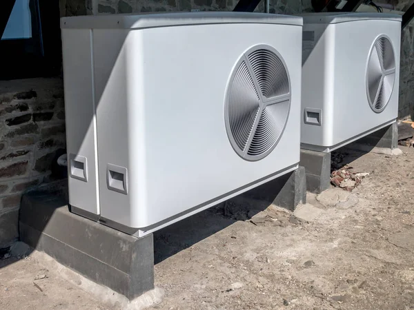 Two residential heat pump units installed outdoors