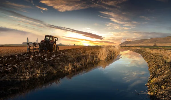 Traktor Membajak Lapangan Malam Hari Saat Matahari Terbenam — Stok Foto