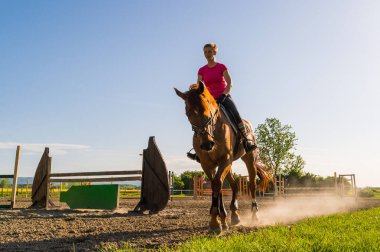 Çiftlikte ata binen güzel genç bir kadın