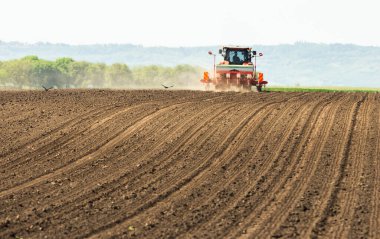 Agricultural machinery - Tractor and seeder for sowing corn clipart