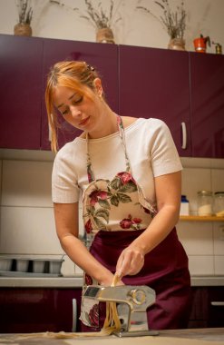 Kız hamur mutfak ve hayalleri kneads. O Ocağın yanında mutfakta yemek hazırlanıyor.