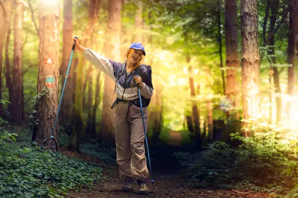 stock image Hiking in the forest. Beautiful young women with big backpack hiking in the deep forest