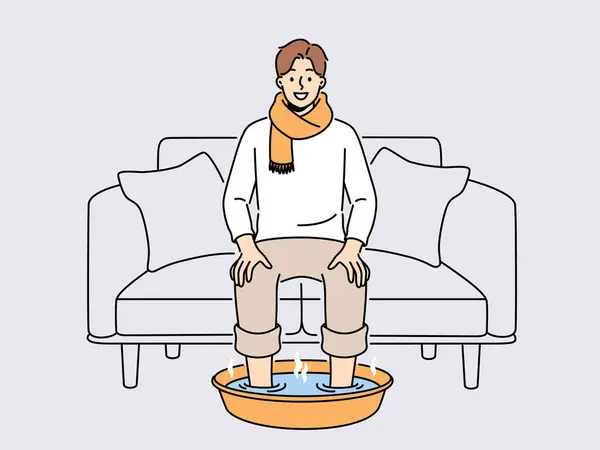 Homme Souriant Écharpe Assis Sur Canapé Maison Tremper Les Pieds — Image vectorielle