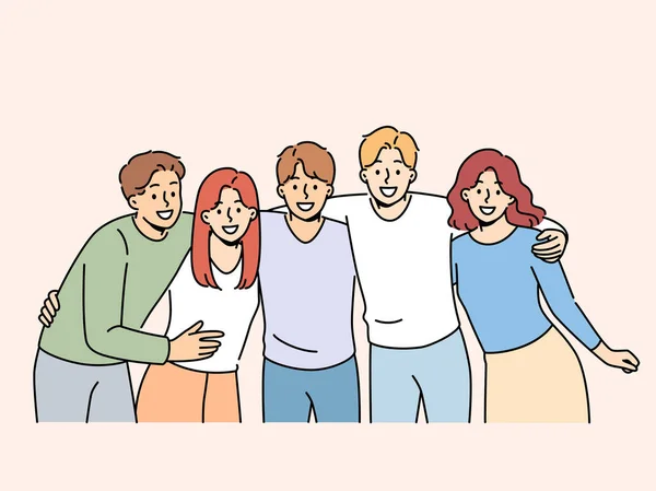 Group of teenagers high school students hug and laugh, enjoy being friends with peers and classmates. Team of happy teenagers looking at screen for advertising educational services