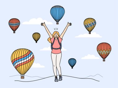 Woman traveler stands among rising balloons and joyfully raises hands up enjoying travel to delightful festival. Concept of travel and getting positive emotions from tours to exotic places clipart