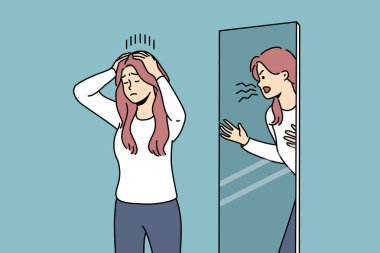 Woman is trying to restrain aggression, standing near mirror with angry reflection, for concept of mental disorder. Girl with mental problems or split personality needs help of psychotherapist clipart