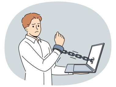 Dizüstü bilgisayara kelepçelenmiş bir adam, internet üzerinden çalışan memurların ve serbest çalışanların köleliğini simgeliyor. Adam online bağımlılık ve kölelikten muzdarip ya da sıkı teslim tarihleriyle ilgili dinlenme eksikliği çekiyor.