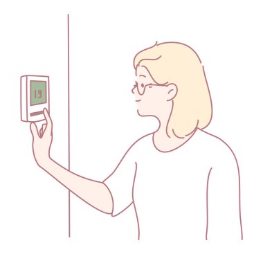 Akıllı bir termostatı ustalıkla ayarlayan bir birey modern ev sıcaklığı kontrolünün kolaylığını gösteriyor.