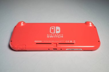 London, UK - 2023.02.13: Detailed close up photo of Coral Nintendo Switch Lite