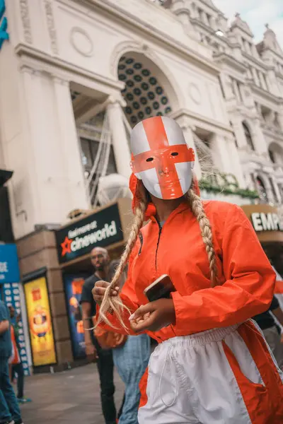 stock image Euro Finals - London - UK - 2024.07.14: Festive football fans wrapped in England flags walk through Central London during the Euro Finals. The lively atmosphere captures the excitement of the sporting event.