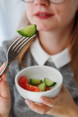 Sebzeli taze salata yiyen bir kadının ağzına yakın plan, diyette otururken alabileceğin yemek. Yüksek kalite fotoğraf
