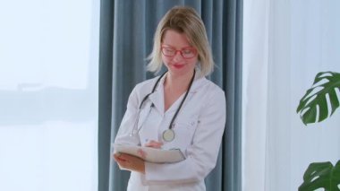Bir doktor hastasıyla konuşuyor ve bazı notlar alıyor. Aşırı kilolu insanlara yardım etmeye çalışan bir beslenme uzmanı. Pozitif doktor konuşuyor. 