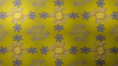 Renkli unsurlarla hareketli arka plan görüntüleri. Çiçekler. Eski model. Bayrak tarzı. Altın, altın. Video kaydı. Şablon.