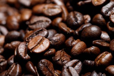 photo macro close up texture of roasted coffee beans dark, can be used as a background.	