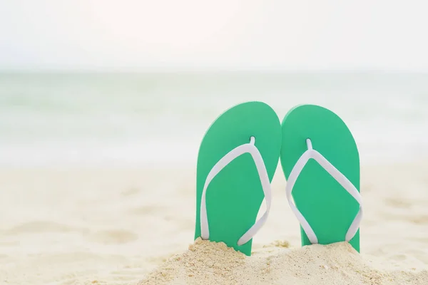 stock image sea on the beach Footprint  people on the sand and slipper of feet in sandals shoes on beach sands background. travel holidays concept.