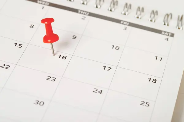 mark the event day with a pin. Thumbtack in calendar concept for busy timeline organize schedule,appointment meeting reminder. planning business meeting or travel holiday planning concept. soft focus