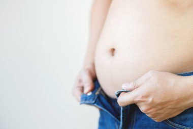 fat mature man check out body overweight abdomen his belly for white or obesity background. Weight loss concept.	