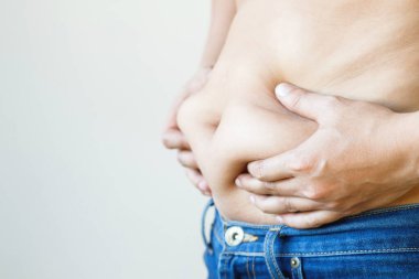 fat mature man check out body overweight abdomen his belly for white or obesity background. Weight loss concept.	