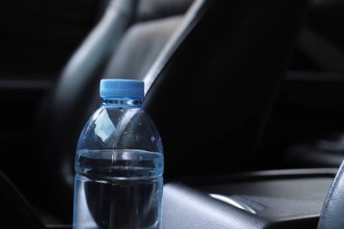 Arabada bir şişe su var.