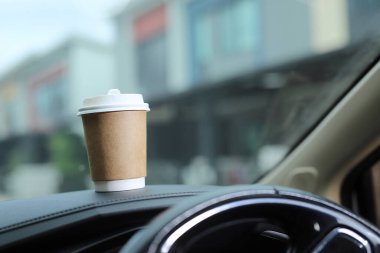 A cup of fresh coffee in the car with the journey