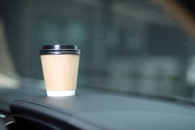 A cup of fresh coffee in the car with the journey