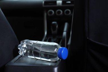 Arabada bir şişe su var.