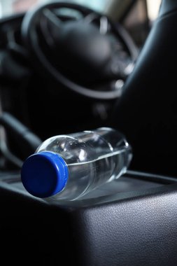Arabada bir şişe su var.
