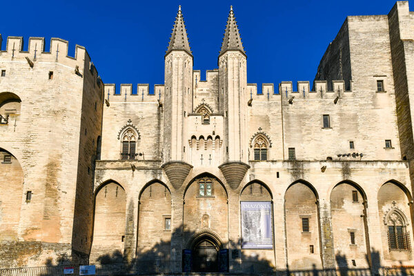 Avignon, France - Jul 16, 2022: Palace of the Popes, once fortress and palace, one of the largest and most important medieval Gothic buildings in Europe in Avignon, France.