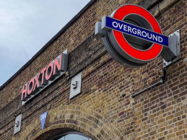 London, UK - Aug 30, 2022: Overground sign for London Transit at Hoxton, UK. clipart